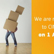 man holding pile of cardboard boxes