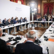 meeting with people seated at table against a  United Nations Ocean Conference backdrop
